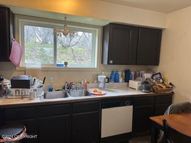 kitchen featuring hanging light fixtures, sink, and white dishwasher