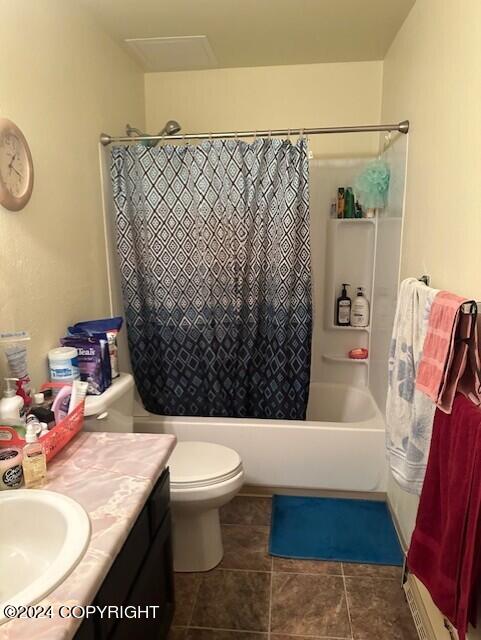 full bathroom with vanity, toilet, tile patterned flooring, and shower / bath combo with shower curtain