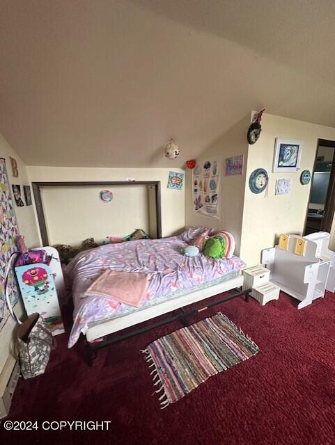 carpeted bedroom featuring vaulted ceiling