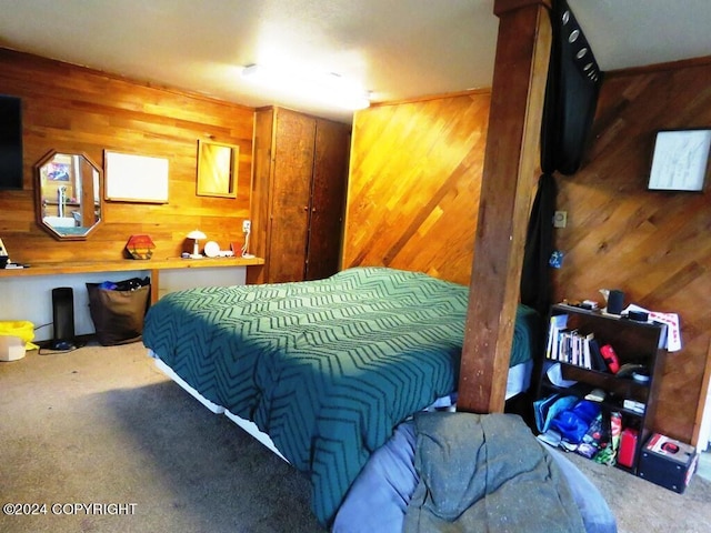 bedroom featuring carpet and wood walls