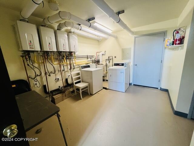 laundry room featuring separate washer and dryer and water heater