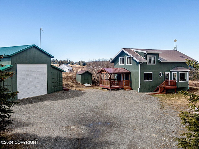 back of property featuring a garage and an outdoor structure