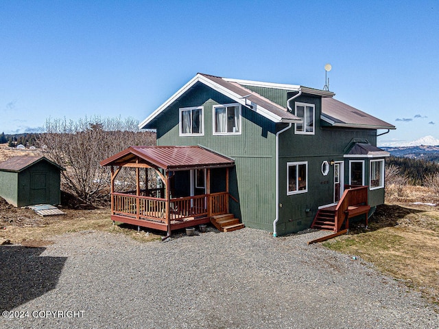 back of property featuring a shed