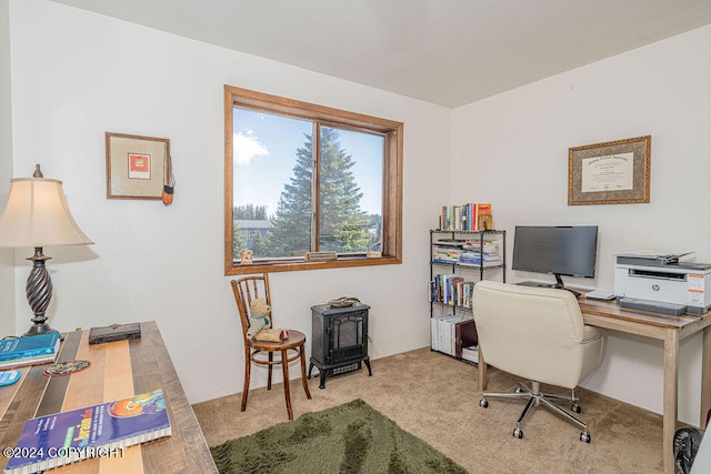 carpeted office featuring a wood stove