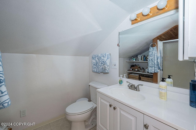 bathroom with tile flooring, vanity, toilet, and lofted ceiling