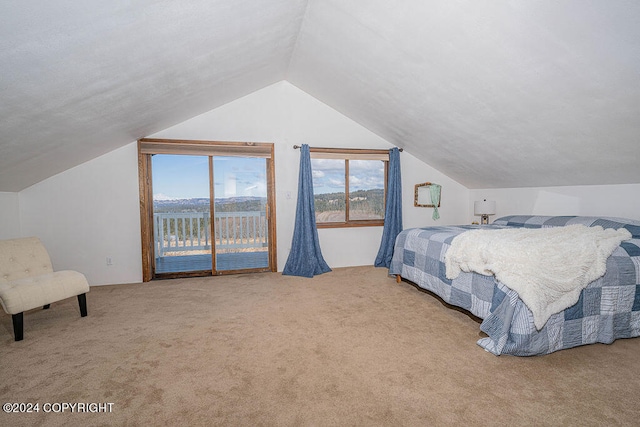 bedroom with a water view, carpet, access to outside, and lofted ceiling