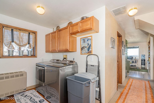 washroom with washer and dryer, cabinets, hookup for a washing machine, and radiator heating unit