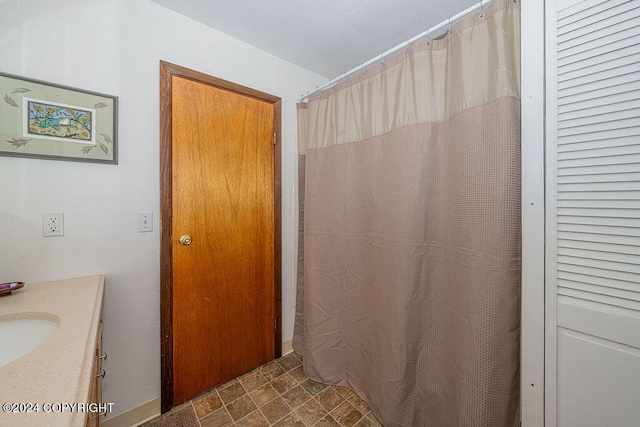 bathroom featuring tile floors and vanity