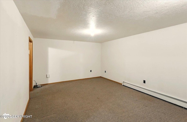 44775 Carver Dr, Kenai, AK 99611 - empty room featuring baseboard heating, carpet floors, a textured ceiling, and baseboards