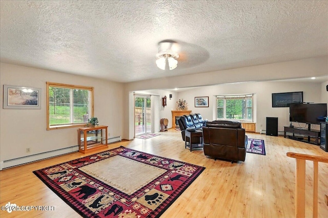 44775 Carver Dr, Kenai, AK 99611 - living area featuring wood finished floors, a ceiling fan, plenty of natural light, and a textured ceiling