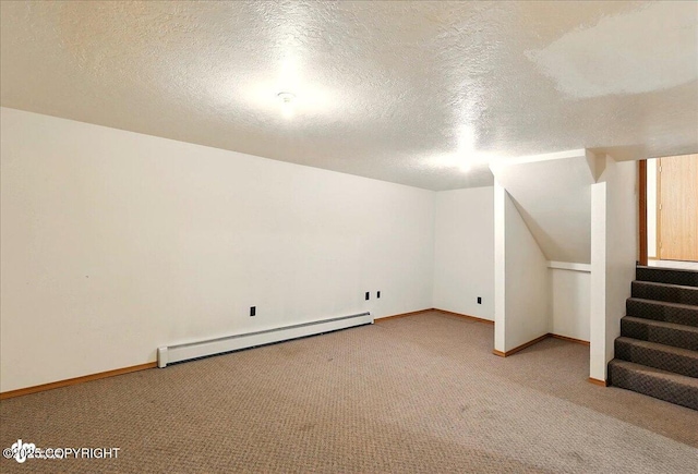 44775 Carver Dr, Kenai, AK 99611 - basement featuring a baseboard heating unit, light colored carpet, a textured ceiling, baseboards, and stairway