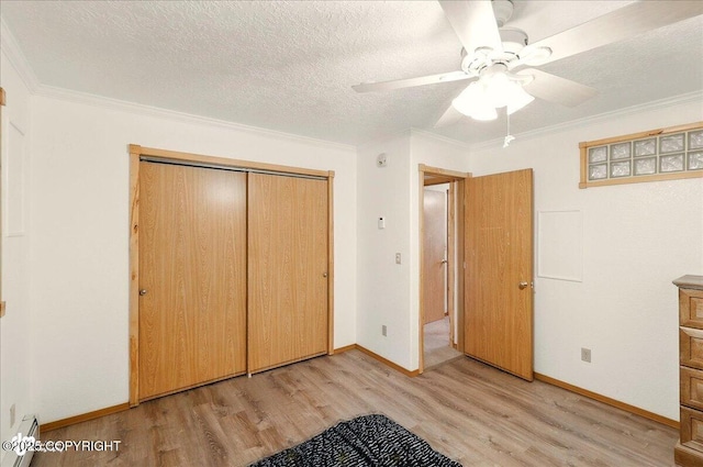 44775 Carver Dr, Kenai, AK 99611 - unfurnished bedroom with a baseboard heating unit, light wood-style floors, a closet, ornamental molding, and baseboards