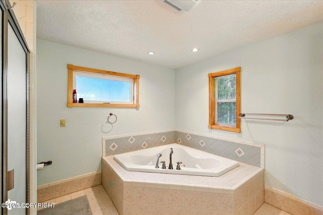 44775 Carver Dr, Kenai, AK 99611 - bathroom featuring a garden tub, plenty of natural light, baseboards, recessed lighting, and a textured ceiling
