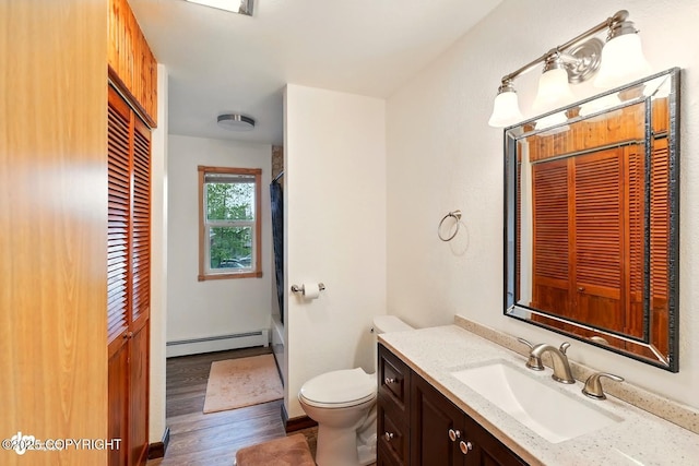 44775 Carver Dr, Kenai, AK 99611 - bathroom featuring a baseboard heating unit, vanity, wood finished floors, toilet, and shower / tub combination