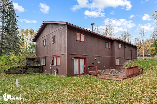 back of house with a yard and a wooden deck