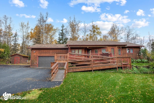 view of front facade with a front lawn, aphalt driveway, and a wooden deck