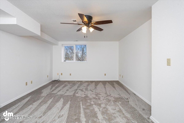 unfurnished room featuring baseboards, light colored carpet, visible vents, and a textured ceiling