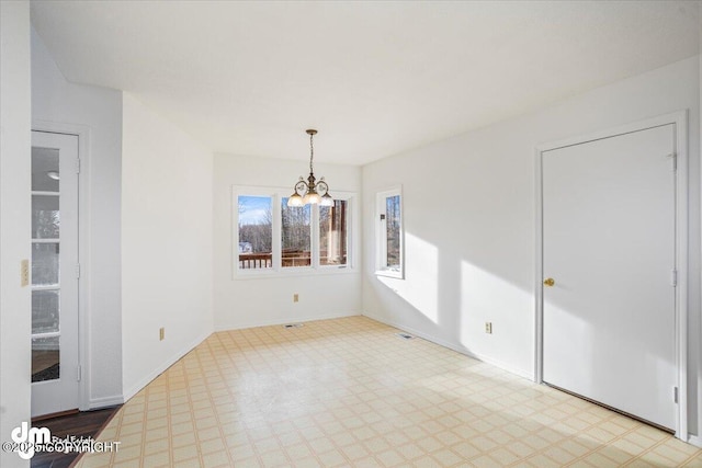 unfurnished dining area with light floors, baseboards, and a chandelier