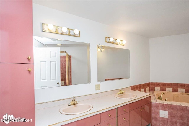 bathroom featuring double vanity, a sink, and a bath