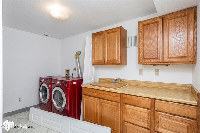 laundry room with cabinet space, baseboards, visible vents, independent washer and dryer, and marble finish floor