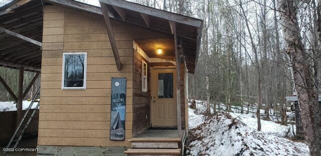 view of snow covered property entrance