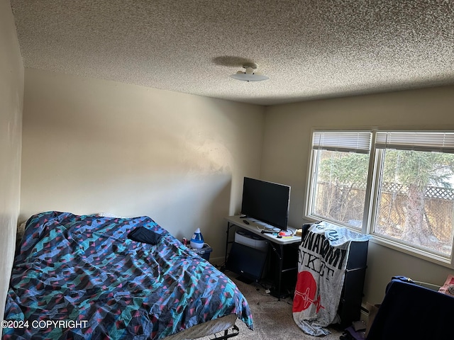 carpeted bedroom featuring a textured ceiling