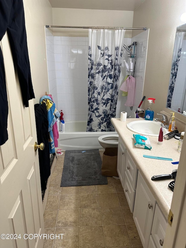 full bathroom with tile floors, toilet, shower / bath combo, and vanity with extensive cabinet space