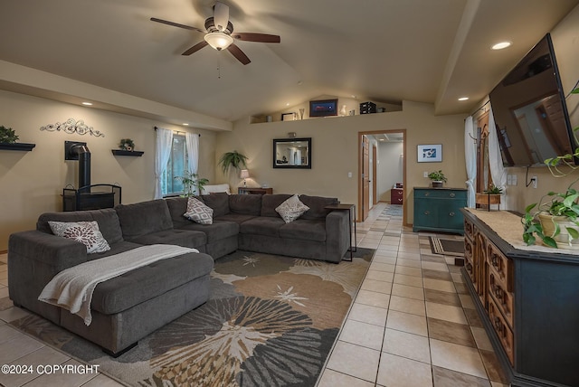 tiled living room featuring ceiling fan, lofted ceiling, and a wood stove