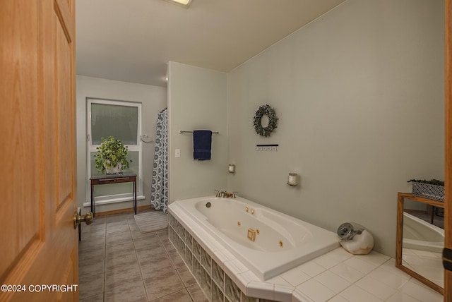 bathroom featuring tile patterned flooring and tiled bath