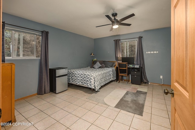 bedroom featuring stainless steel refrigerator, ceiling fan, and light tile patterned flooring