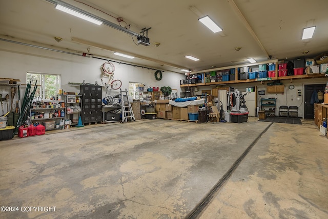 garage featuring a garage door opener and a workshop area