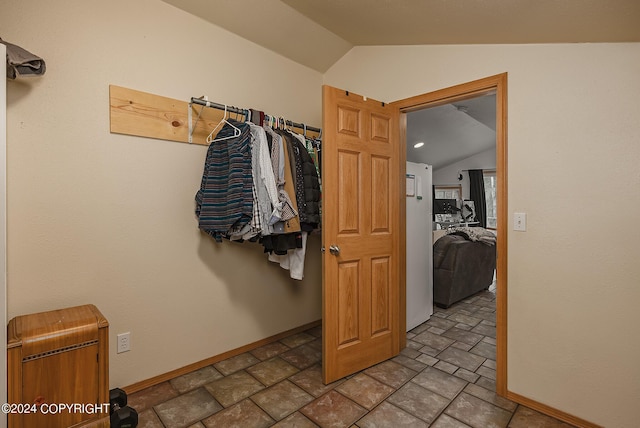 walk in closet featuring lofted ceiling