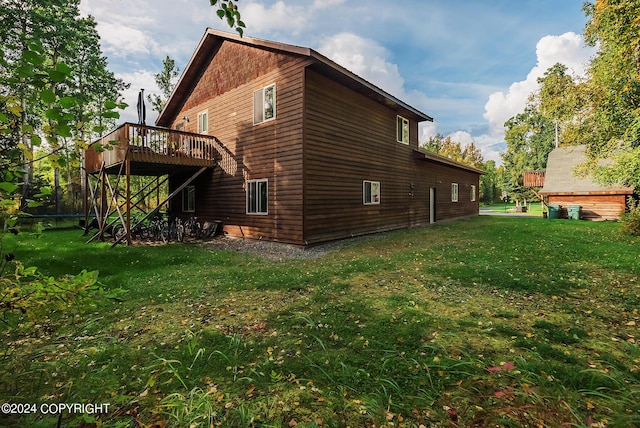 view of home's exterior featuring a yard and a deck