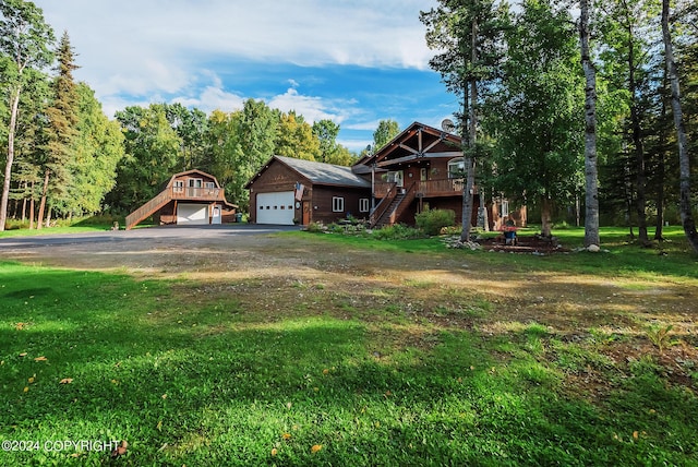 view of front facade with a garage, a deck, and a front yard