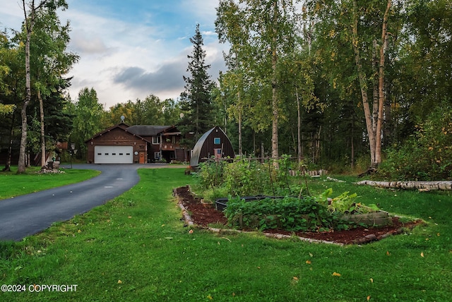 view of front of house featuring a garage and a front lawn