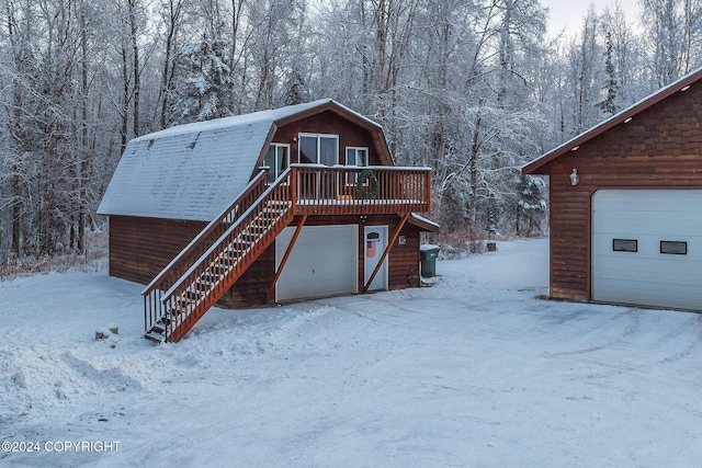 view of front facade with a garage and a deck