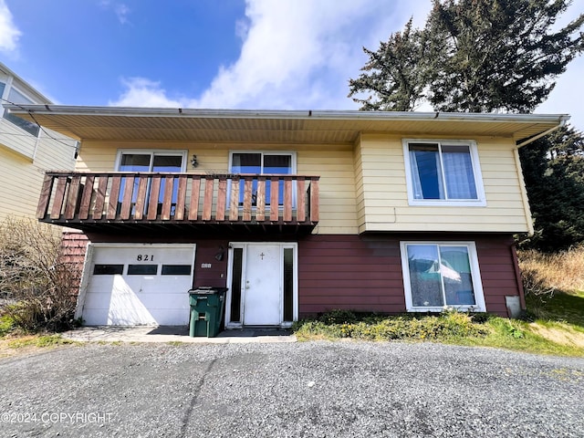 view of front of home featuring a garage and a balcony