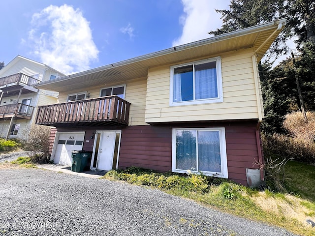 rear view of property featuring a balcony