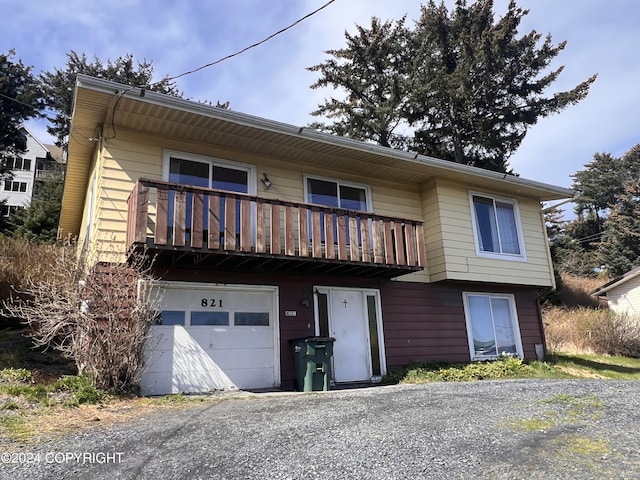 view of front of property with a garage and a balcony