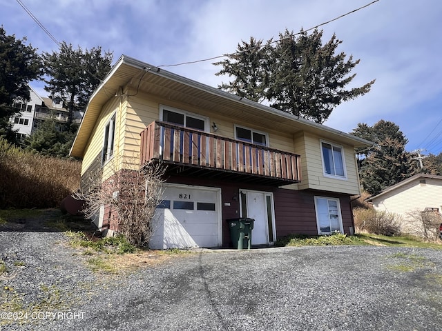 view of front property with a garage and a balcony