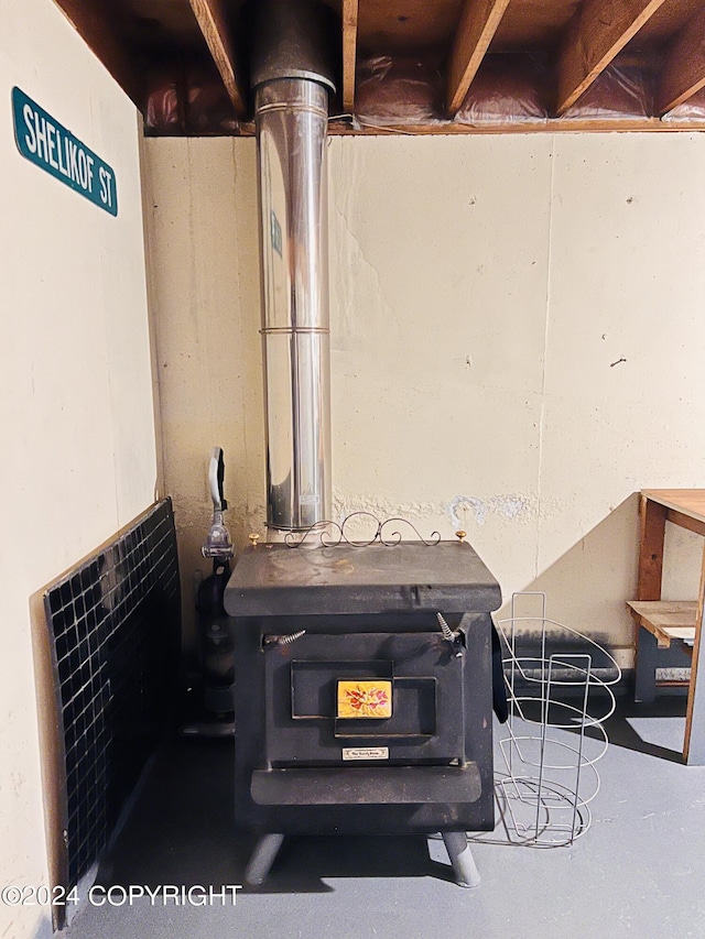 room details with concrete flooring and a wood stove