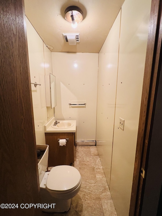 bathroom with tile floors, toilet, and vanity