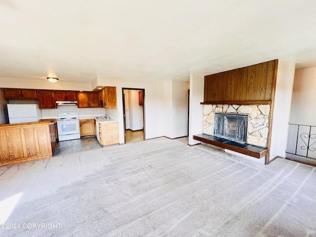 unfurnished living room with sink, a fireplace, and tile flooring