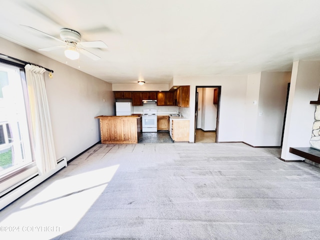 unfurnished living room with a baseboard radiator, ceiling fan, and light colored carpet