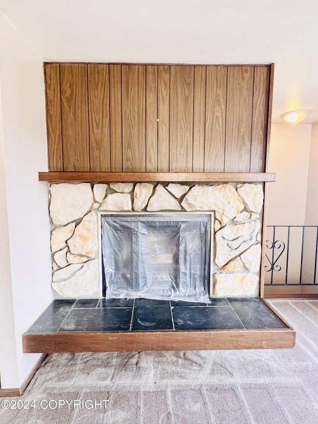 room details featuring carpet and a fireplace