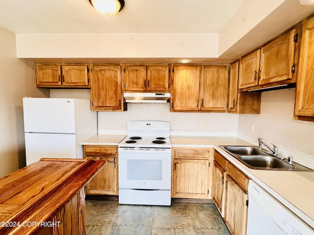 kitchen featuring sink, white appliances, and light tile floors