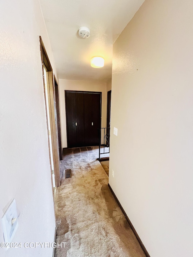 hallway featuring carpet flooring