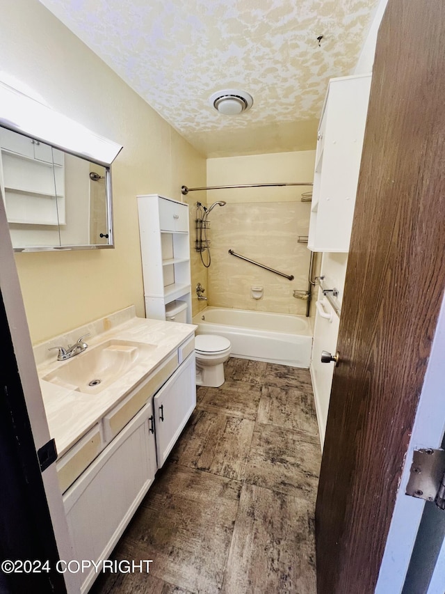 full bathroom with oversized vanity, toilet, tile floors, tub / shower combination, and a textured ceiling