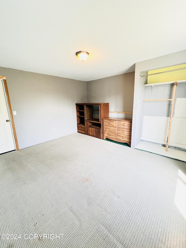 unfurnished living room featuring carpet flooring