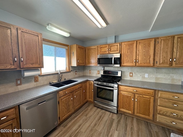 kitchen featuring appliances with stainless steel finishes, backsplash, and sink